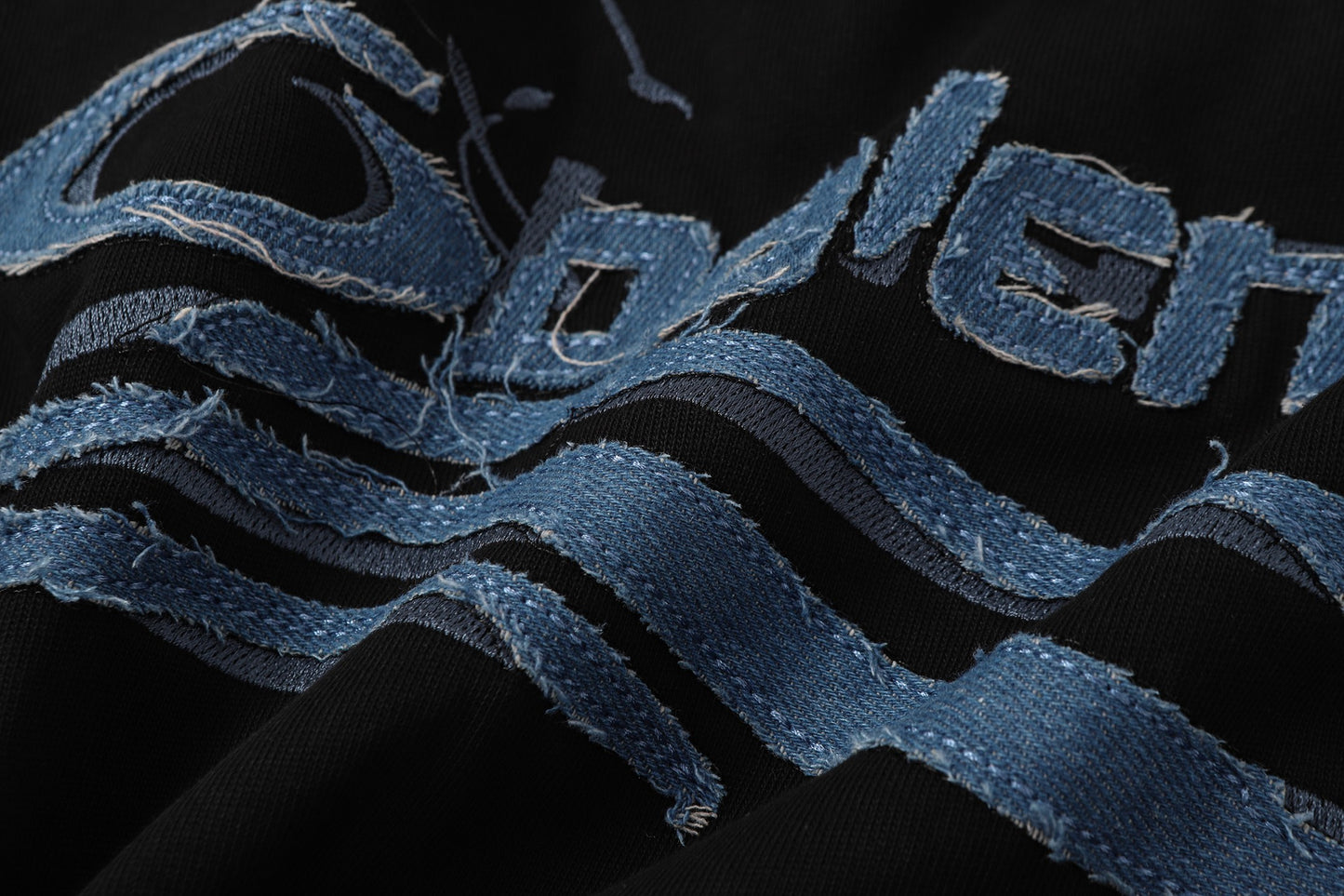 Balenciaga T-shirt featuring intricate, high-density, double-layered 3D embroidery and a washed-denim appliqué.