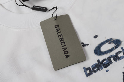 Balenciaga T-shirt featuring intricate, high-density, double-layered 3D embroidery and a washed-denim appliqué.