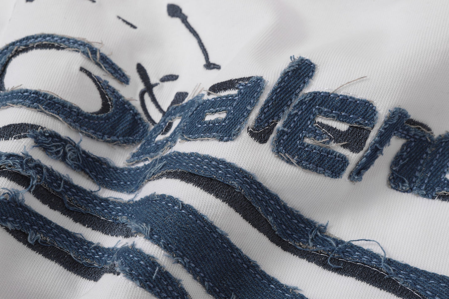 Balenciaga T-shirt featuring intricate, high-density, double-layered 3D embroidery and a washed-denim appliqué.
