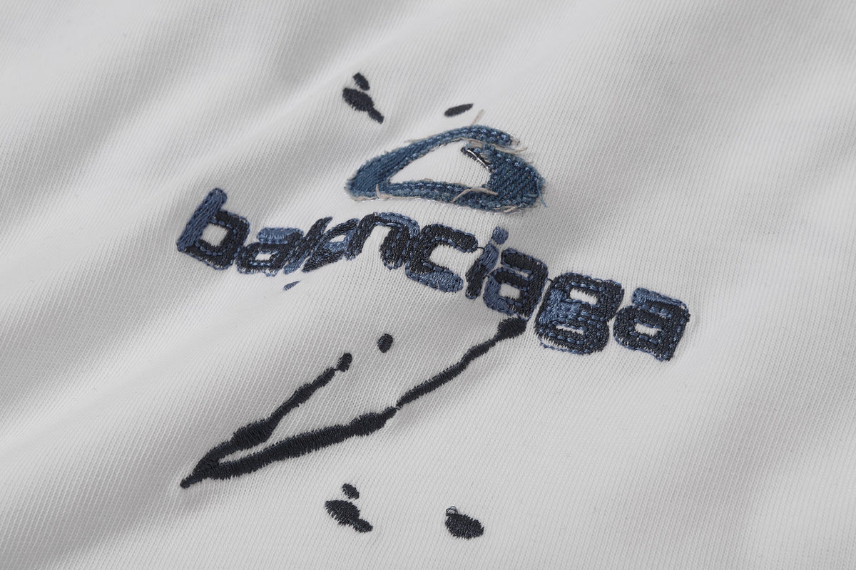 Balenciaga T-shirt featuring intricate, high-density, double-layered 3D embroidery and a washed-denim appliqué.