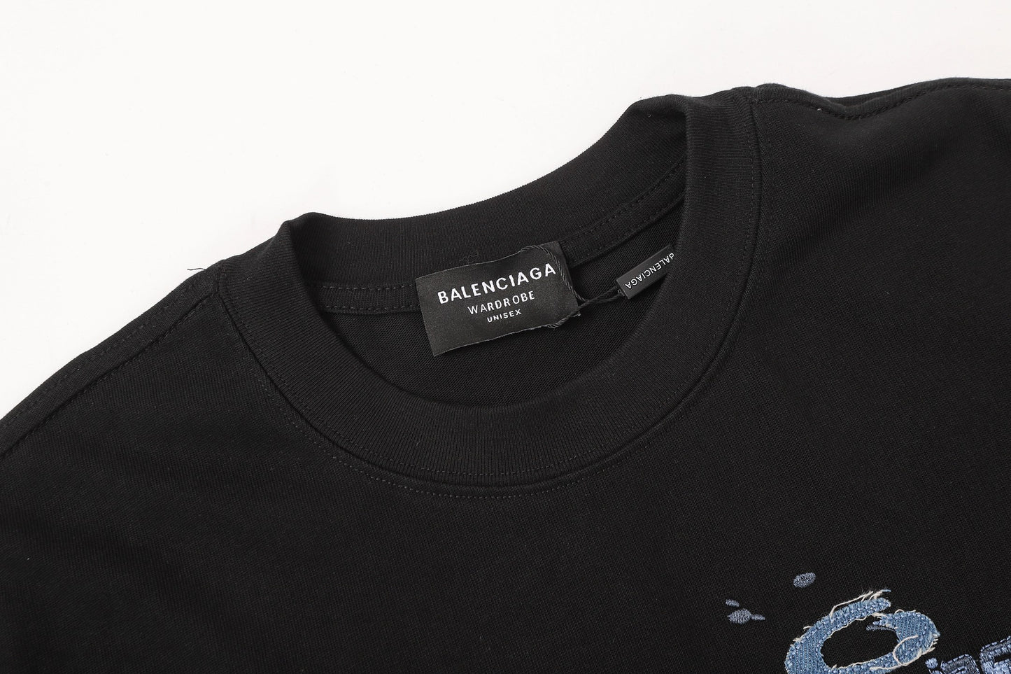 Balenciaga T-shirt featuring intricate, high-density, double-layered 3D embroidery and a washed-denim appliqué.