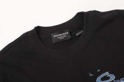 Balenciaga T-shirt featuring intricate, high-density, double-layered 3D embroidery and a washed-denim appliqué.