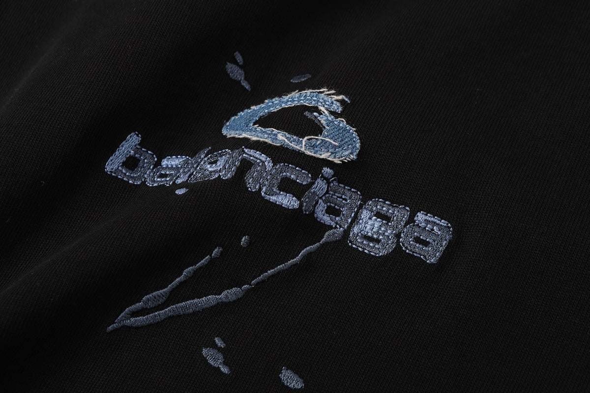 Balenciaga T-shirt featuring intricate, high-density, double-layered 3D embroidery and a washed-denim appliqué.