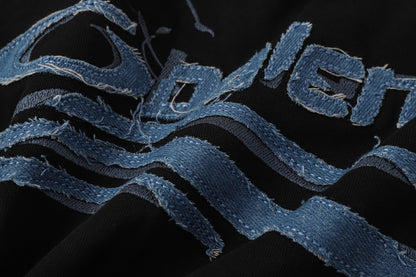Balenciaga T-shirt featuring intricate, high-density, double-layered 3D embroidery and a washed-denim appliqué.